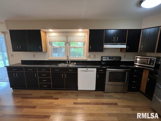 849 E Franklin St, Macomb, IL 61455 - kitchen with stainless steel appliances, a sink, under cabinet range hood, dark countertops, and dark cabinets