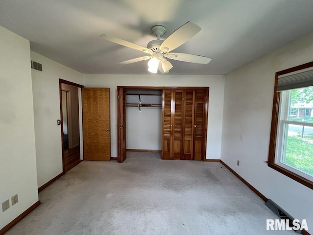849 E Franklin St, Macomb, IL 61455 - unfurnished bedroom featuring a closet, baseboards, and light carpet