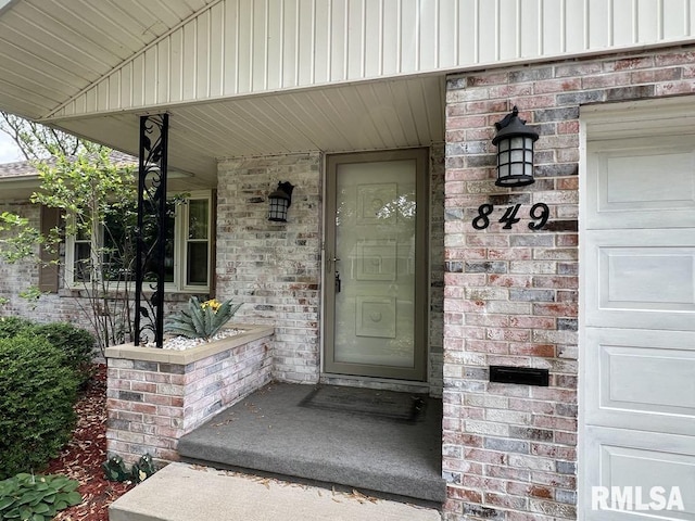 849 E Franklin St, Macomb, IL 61455 - doorway to property with brick siding and covered porch