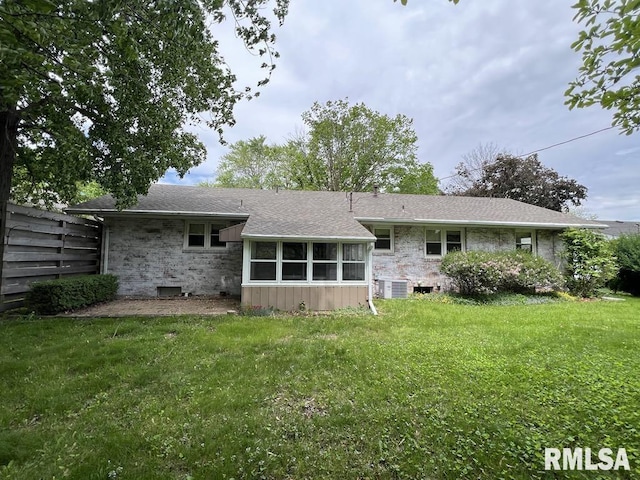 849 E Franklin St, Macomb, IL 61455 - back of property with central air condition unit, a yard, and a shingled roof