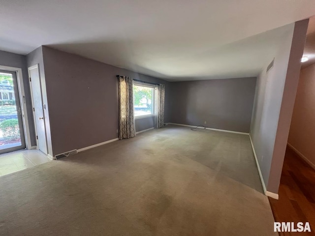 849 E Franklin St, Macomb, IL 61455 - spare room featuring baseboards and light carpet