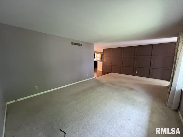 849 E Franklin St, Macomb, IL 61455 - unfurnished room featuring a decorative wall, carpet flooring, and baseboards