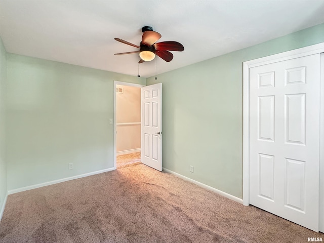 unfurnished bedroom with a closet, ceiling fan, and carpet