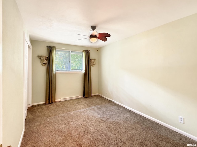 unfurnished room with a baseboard heating unit, ceiling fan, and carpet flooring