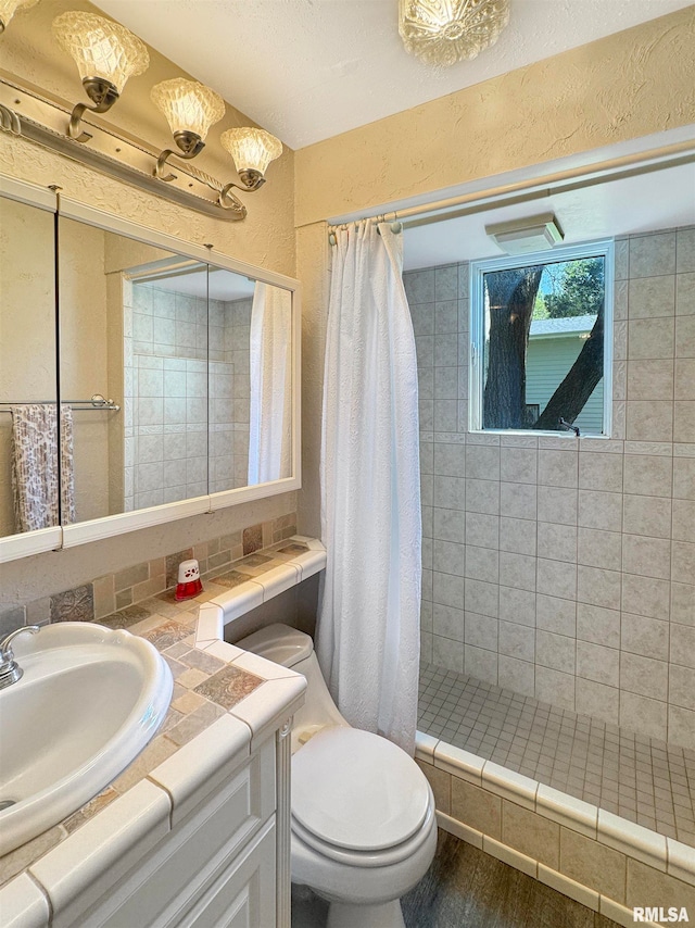 bathroom with a shower with curtain, toilet, hardwood / wood-style flooring, and vanity