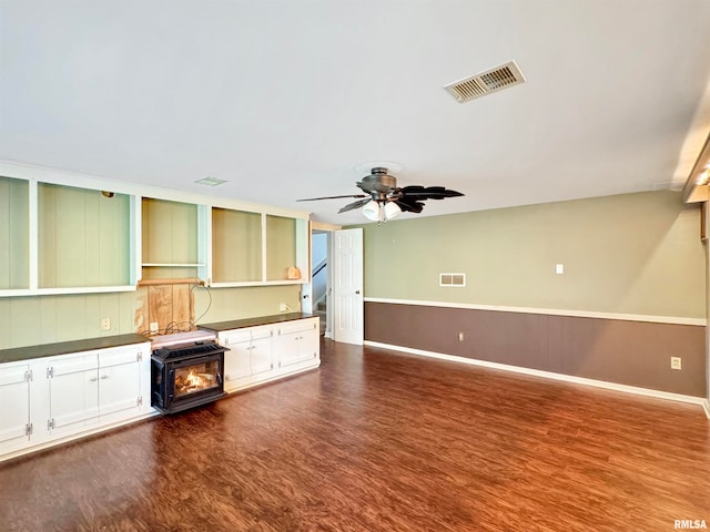 unfurnished living room featuring ceiling fan and dark hardwood / wood-style floors