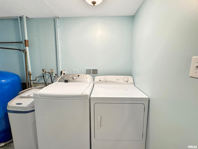 washroom with independent washer and dryer