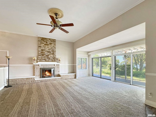 unfurnished living room featuring ornamental molding, a brick fireplace, brick wall, and ceiling fan