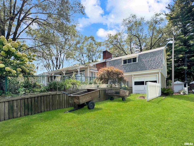 back of house featuring a lawn and a garage