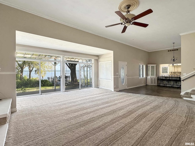 unfurnished living room featuring crown molding, ceiling fan, and dark wood-type flooring