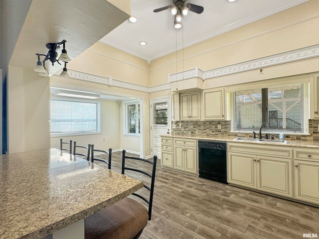 kitchen featuring dishwasher, tasteful backsplash, sink, ceiling fan, and light wood-type flooring