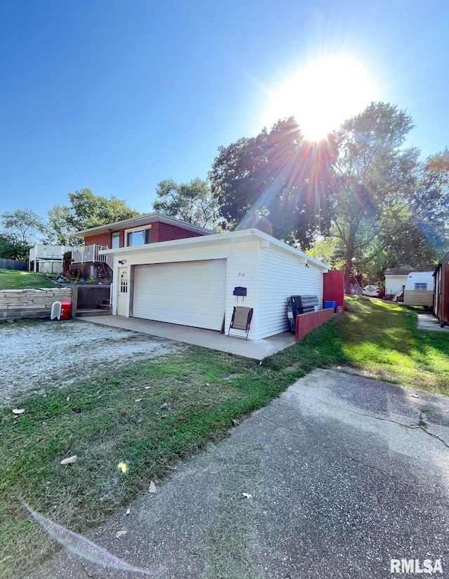 view of property exterior with a yard and a garage