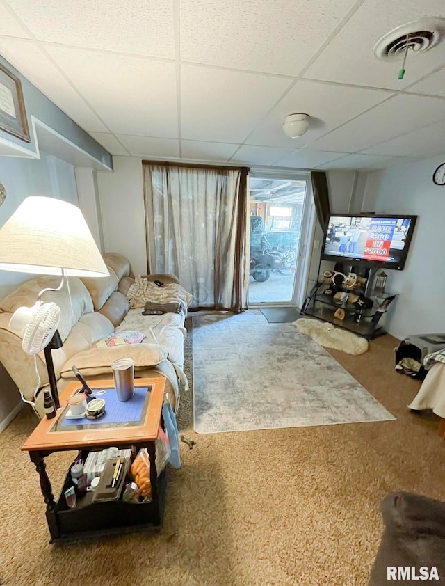 carpeted living room with a paneled ceiling