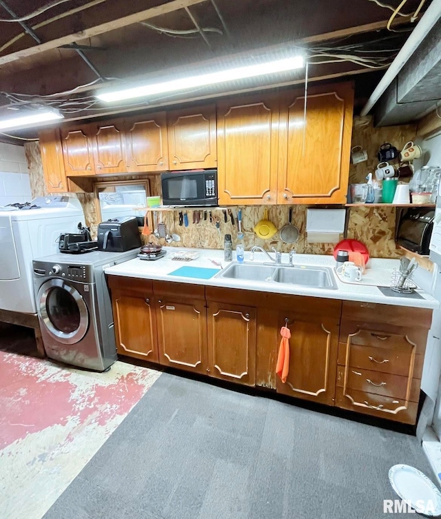 interior space with washing machine and clothes dryer and sink