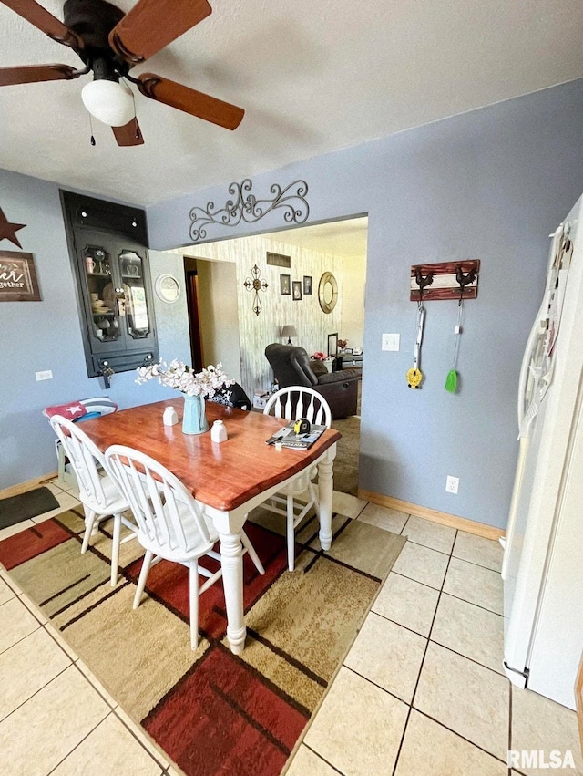 dining space featuring light tile patterned floors and ceiling fan