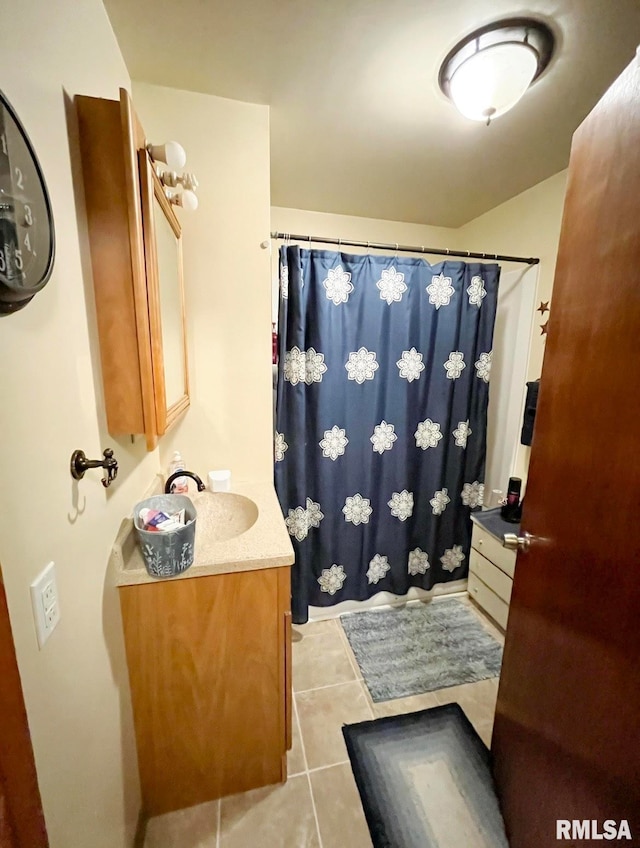 bathroom with vanity, a shower with curtain, and tile patterned flooring