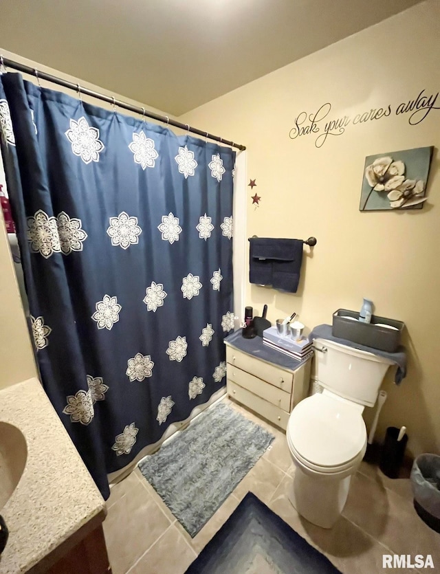 bathroom featuring a shower with shower curtain, vanity, toilet, and tile patterned floors