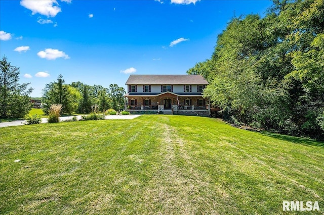 back of property with a lawn and covered porch