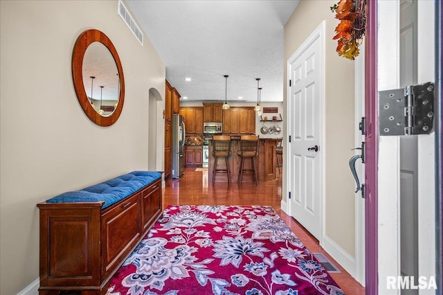 hallway featuring a textured ceiling and dark hardwood / wood-style floors