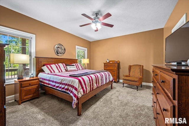 carpeted bedroom featuring a textured ceiling and ceiling fan