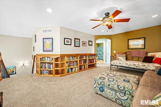 carpeted bedroom featuring ceiling fan, a textured ceiling, and vaulted ceiling