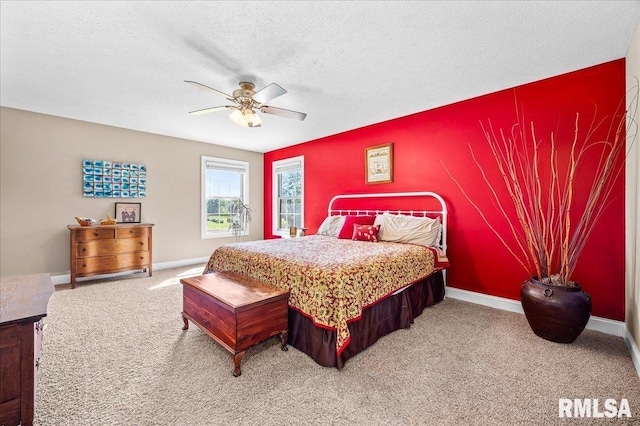 carpeted bedroom with ceiling fan and a textured ceiling