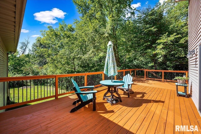 wooden terrace featuring a yard