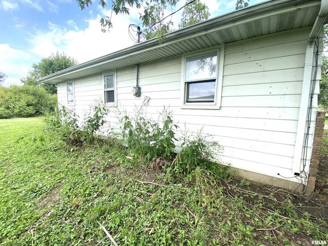 view of side of home with a lawn