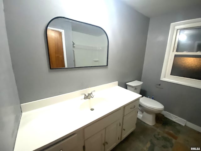 bathroom featuring baseboards, visible vents, vanity, and toilet