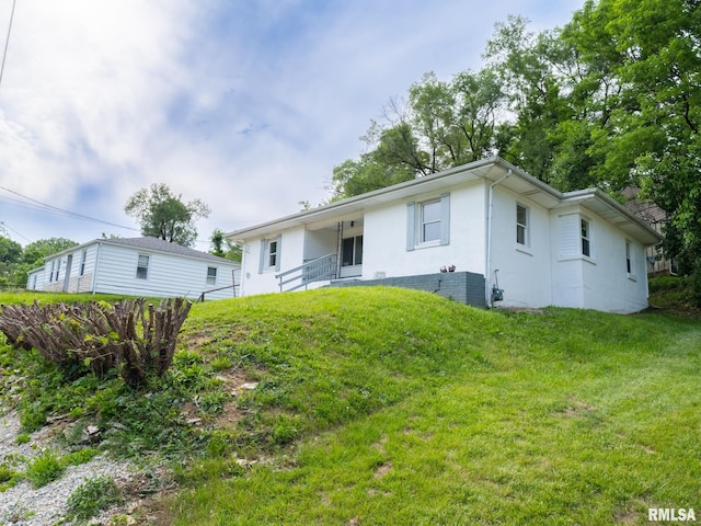 rear view of property with a lawn