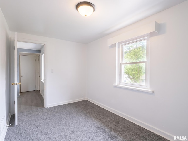 carpeted spare room with baseboards