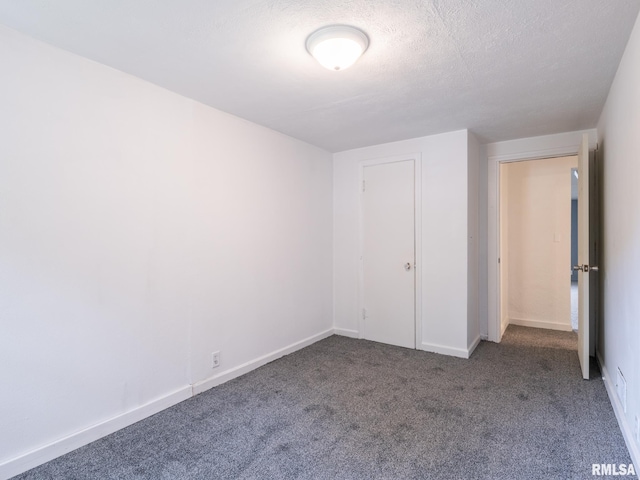 unfurnished bedroom featuring baseboards, carpet floors, and a textured ceiling