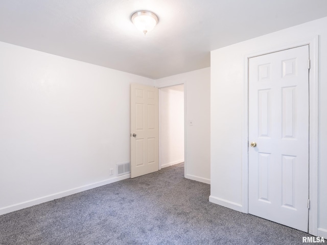 unfurnished bedroom featuring carpet, visible vents, and baseboards