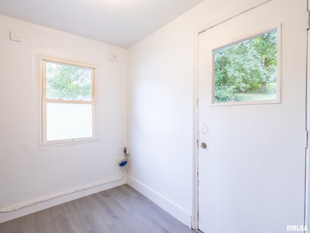 unfurnished room featuring light wood-style flooring and baseboards