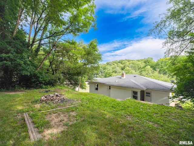 view of yard with a fire pit