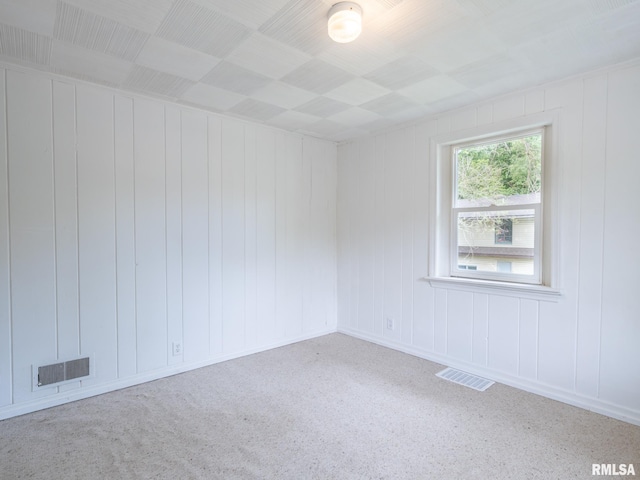 unfurnished room with visible vents