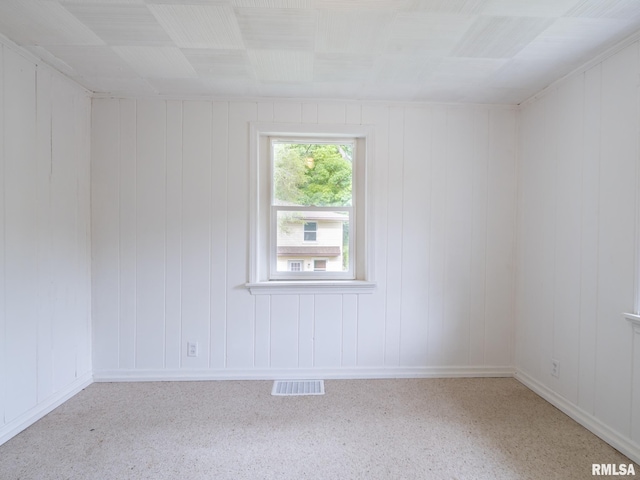 unfurnished room with visible vents