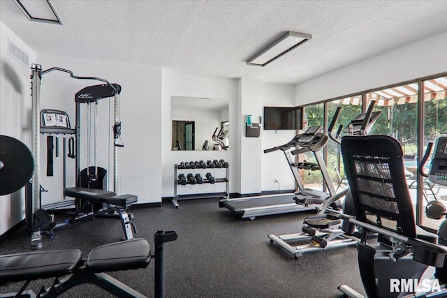 exercise room featuring a textured ceiling