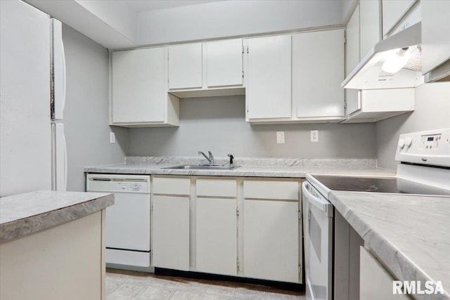 kitchen featuring white cabinets, sink, and white appliances