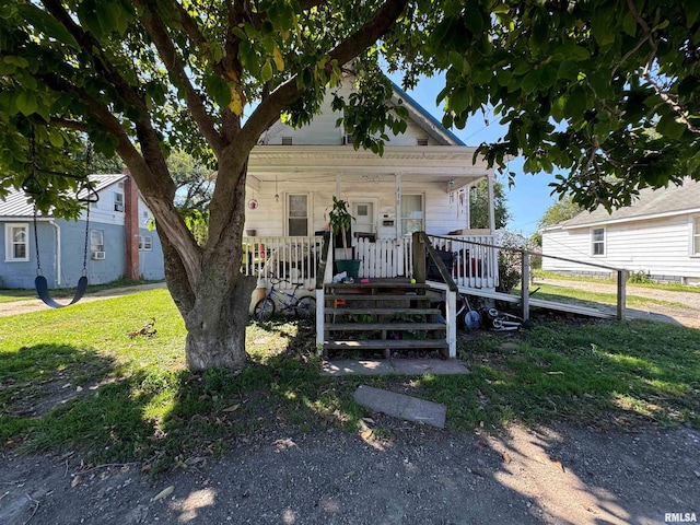 view of front of house featuring a front yard and a porch