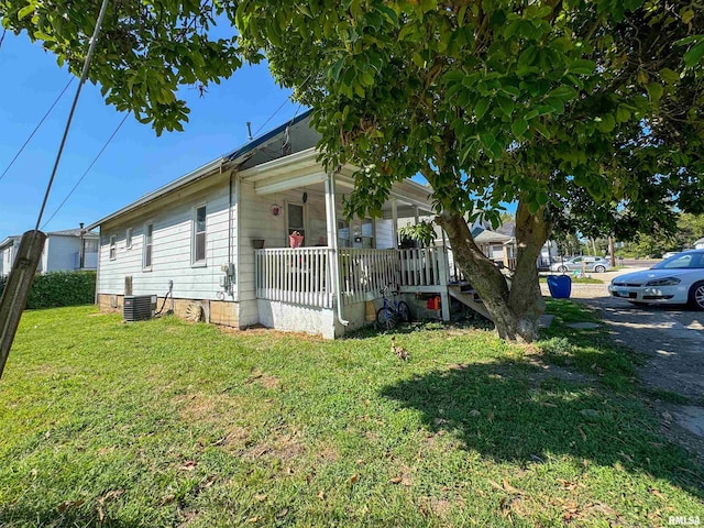 view of property exterior with a yard, central AC unit, and a porch