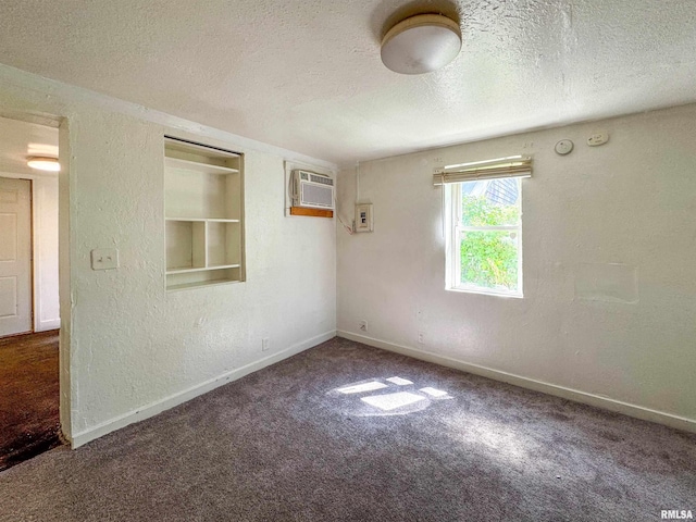 spare room with a textured ceiling and carpet flooring