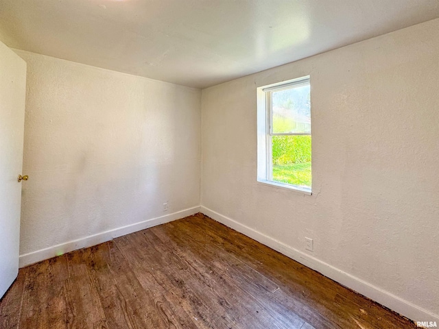 unfurnished room with wood-type flooring