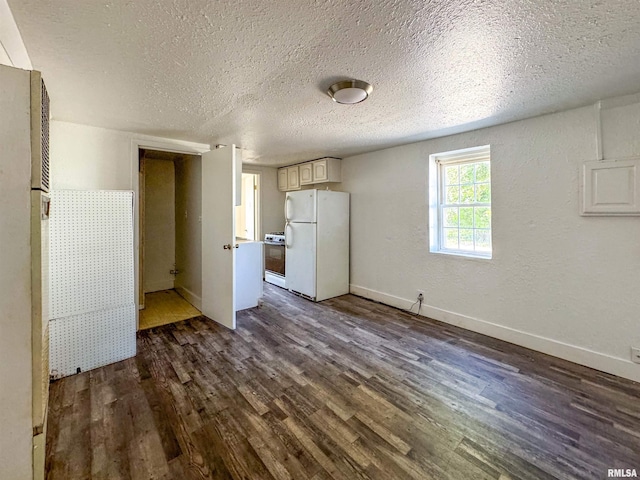 interior space featuring a textured ceiling, white appliances, and dark hardwood / wood-style flooring