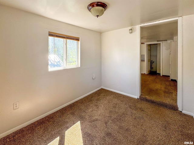 empty room with dark colored carpet