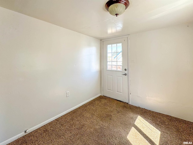 doorway to outside featuring carpet floors