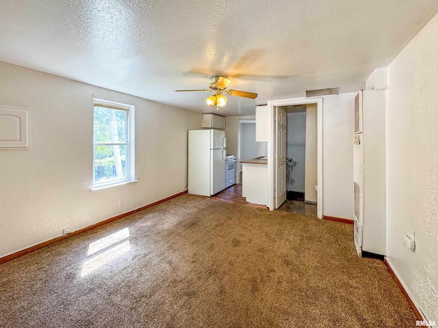 unfurnished living room featuring dark colored carpet, a textured ceiling, and ceiling fan