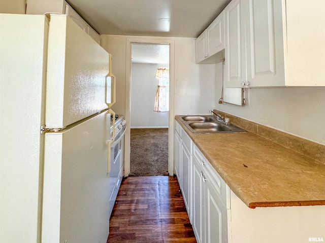 kitchen with white appliances, dark wood-type flooring, sink, and white cabinets