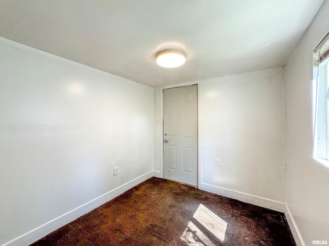 carpeted empty room featuring a wealth of natural light