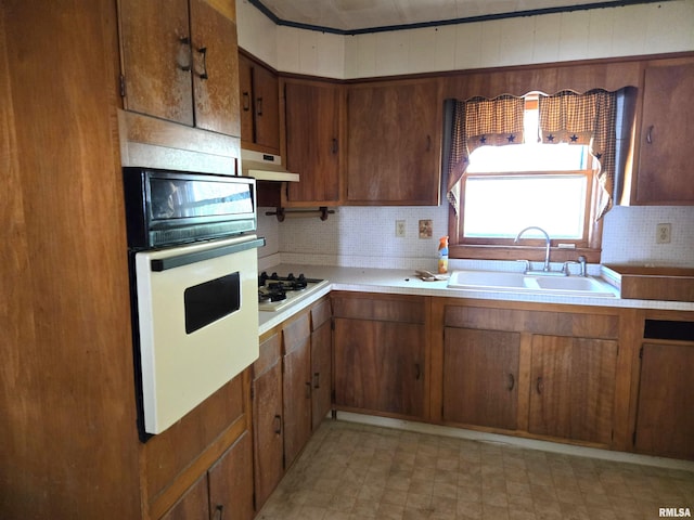 kitchen featuring sink and white appliances